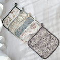 Load image into Gallery viewer, Set of four floral patterned pot holders on a white surface
